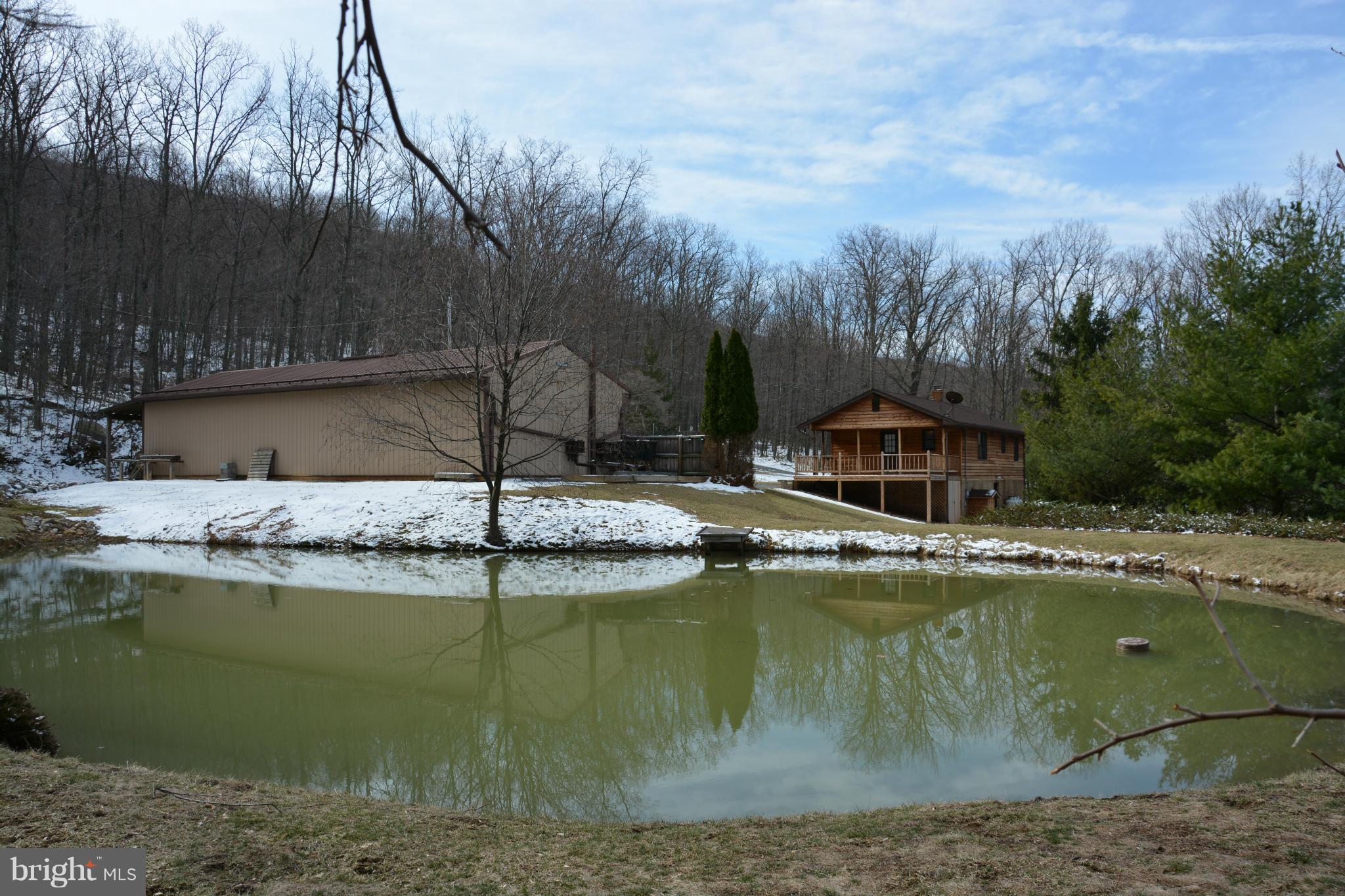 523 Sawlog Road Gore, VA 22637 - Photo 29 of 30 a view of a lake with a house in the background