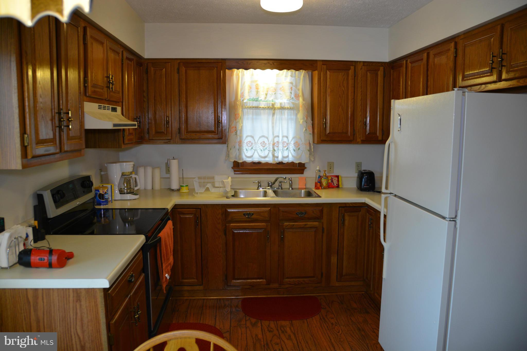 523 Sawlog Road Gore, VA 22637 - Photo 4 of 30 a kitchen with stainless steel appliances granite countertop a refrigerator a sink dishwasher a stove with wooden cabinets and floor