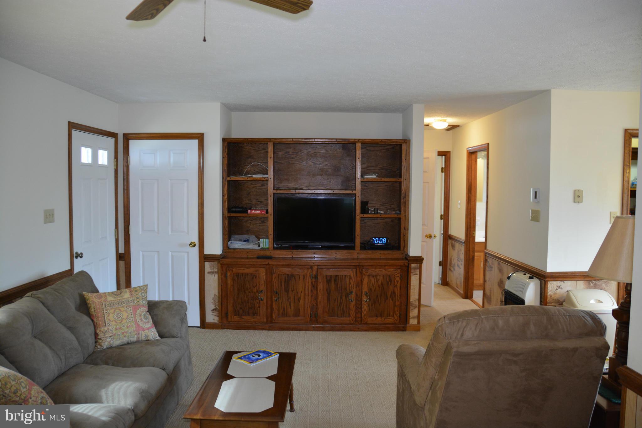 523 Sawlog Road Gore, VA 22637 - Photo 6 of 30 a living room with furniture and a flat screen tv