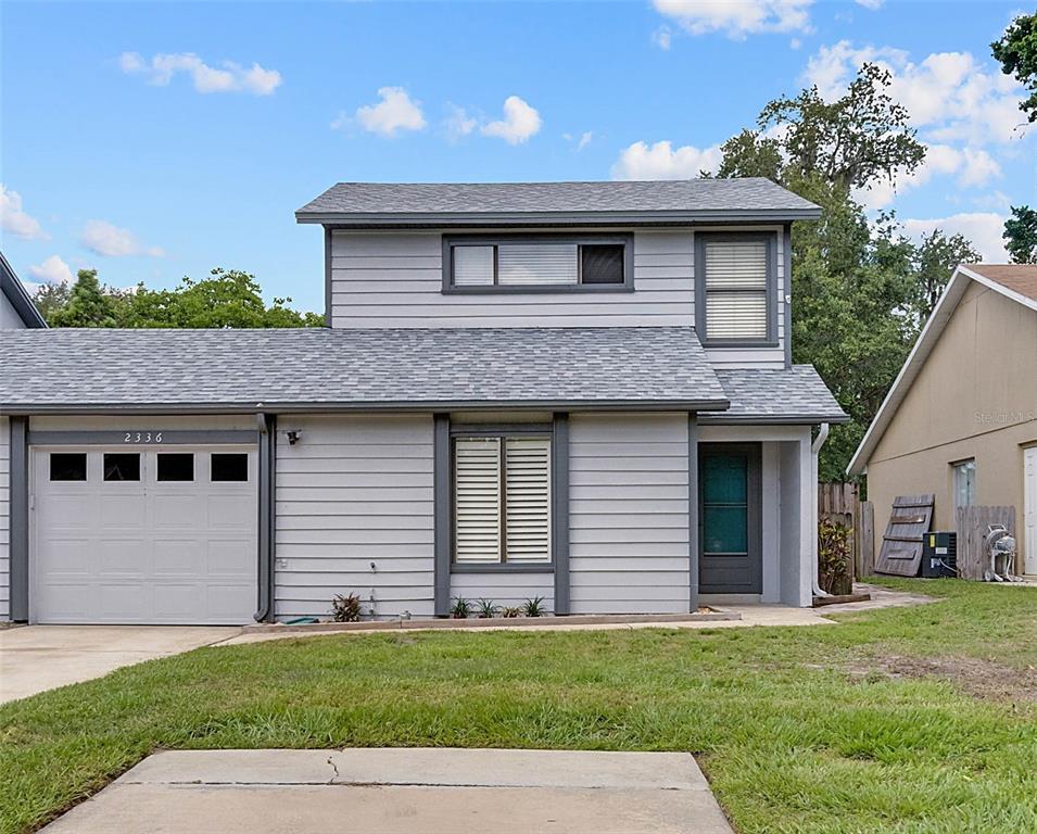 2336 Pear Tree Court Orlando, FL 32807 - Photo 1 of 1 a front view of a house with a garden