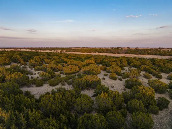 a view of a lake with sunset in background