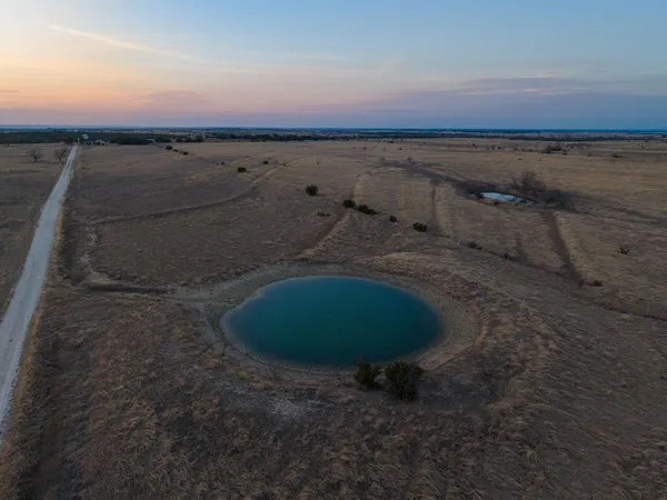 a view of a lake and green valley