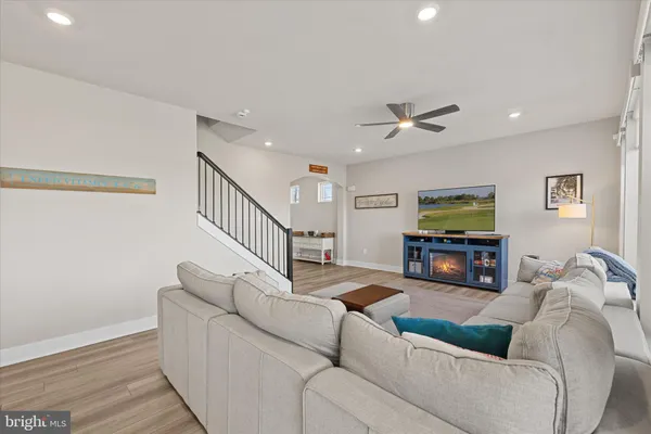 a large white kitchen with a large kitchen island white cabinets and stainless steel appliances