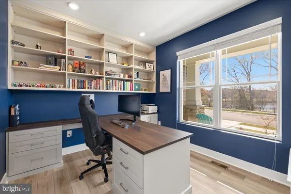 a view of a workspace with furniture and wooden floor