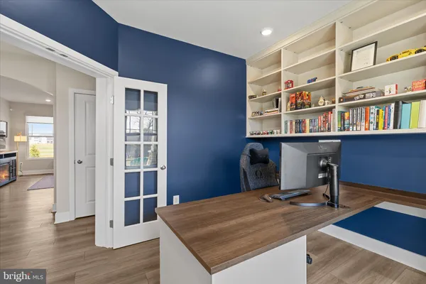 a living room with furniture and a view of kitchen
