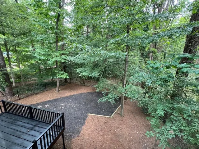 a view of a wooden deck and a backyard