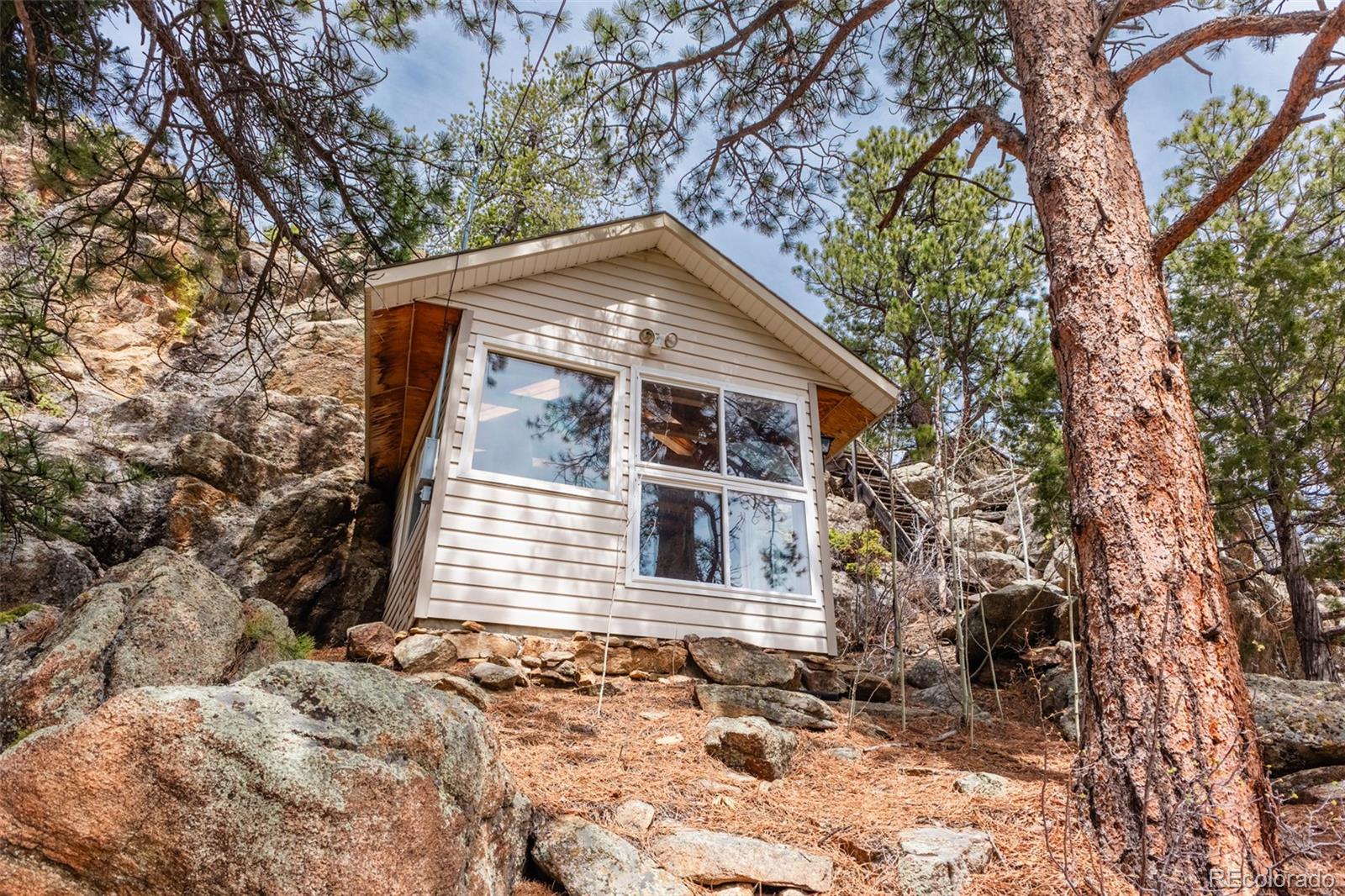24 Pine Valley Road Evergreen, CO 80439 - Photo 39 of 50 a front view of a house with a yard