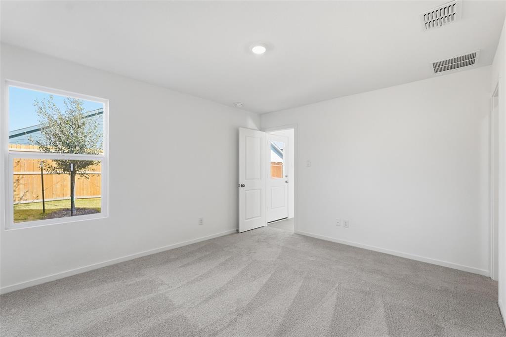 3919 Selawik Street Sherman, TX 75090 - Photo 12 of 21 an empty room with windows