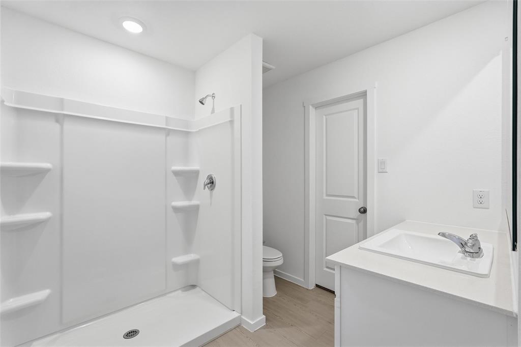 3919 Selawik Street Sherman, TX 75090 - Photo 16 of 21 a bathroom with a sink a toilet and shower