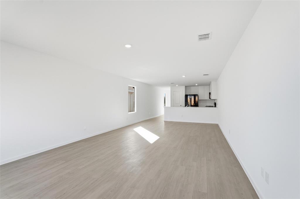 3919 Selawik Street Sherman, TX 75090 - Photo 2 of 21 a view of a kitchen with wooden floor and a sink