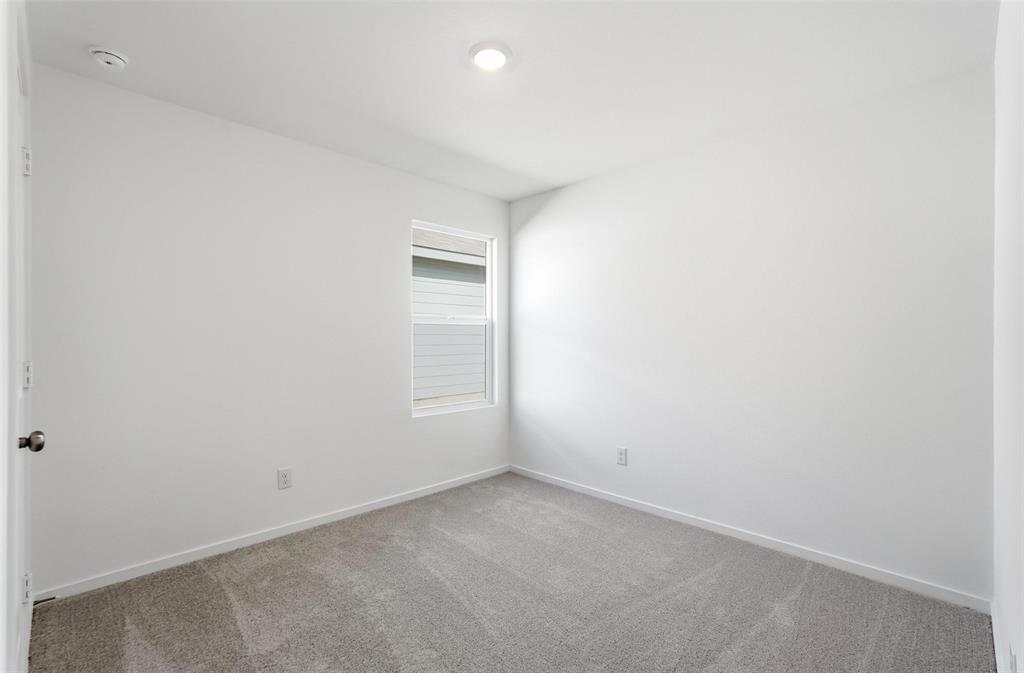 3919 Selawik Street Sherman, TX 75090 - Photo 9 of 21 an empty room with a empty space and window