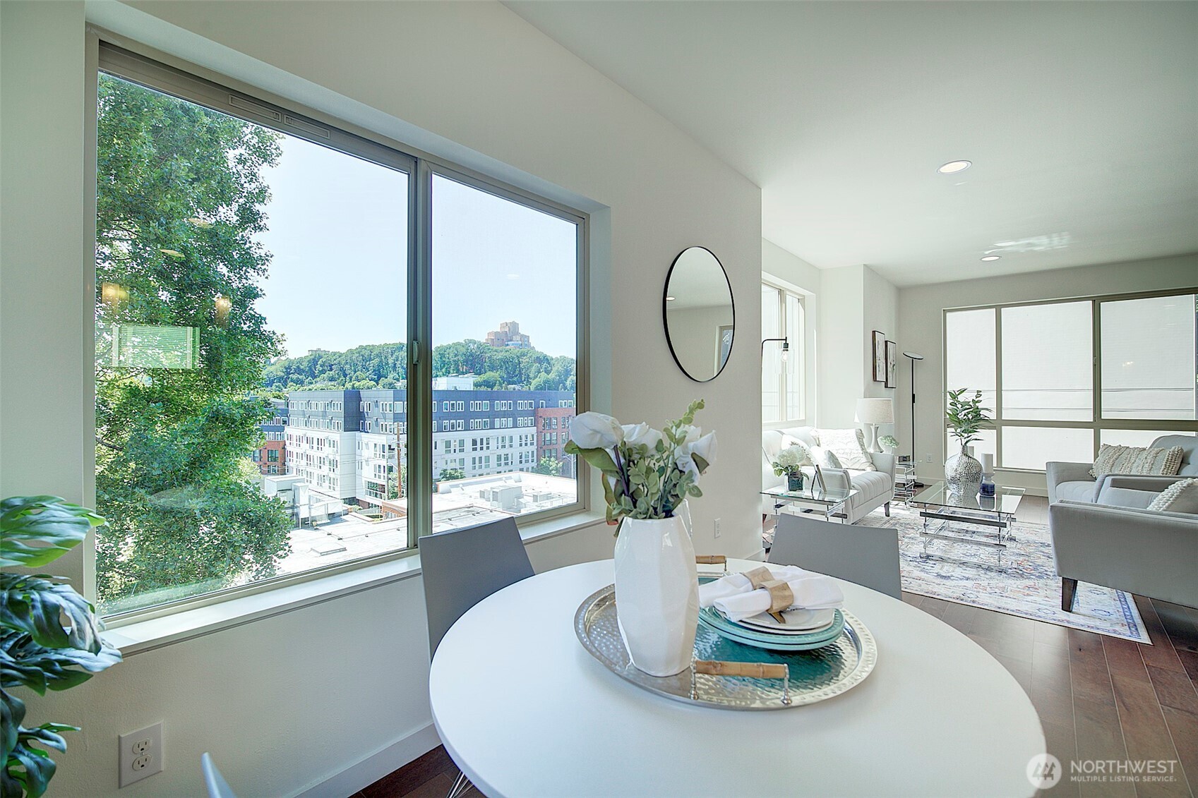 1617 South Weller Street Seattle, WA 98144 - Photo 3 of 19 a dining room with furniture a large window and wooden floor