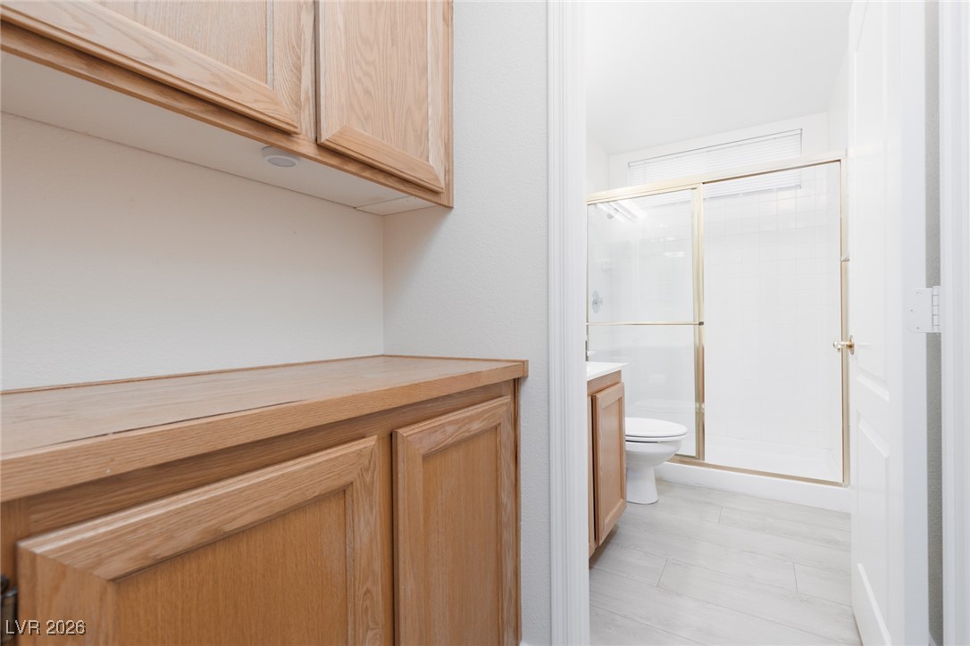 1828 Jack Rabbit Way Las Vegas, NV 89128 - Photo 17 of 39 Linen storage looking into downstairs 3/4 bath