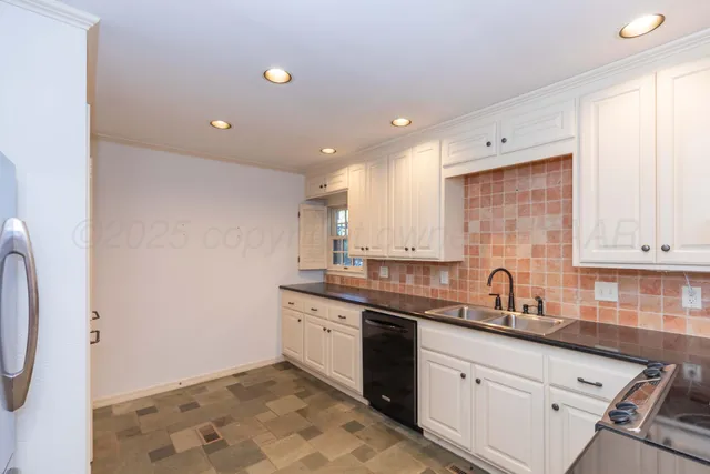 a kitchen with a sink and cabinets