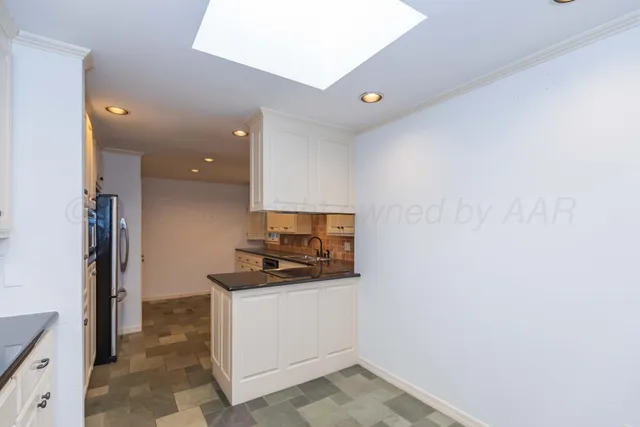 a kitchen with a sink and a stove top oven