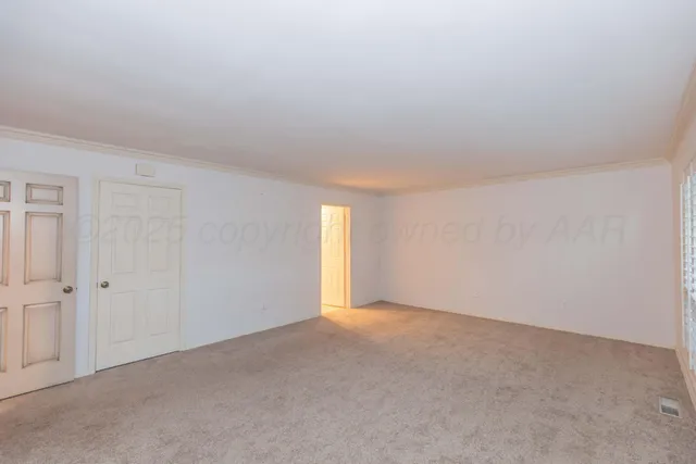 a view of an empty room and a window