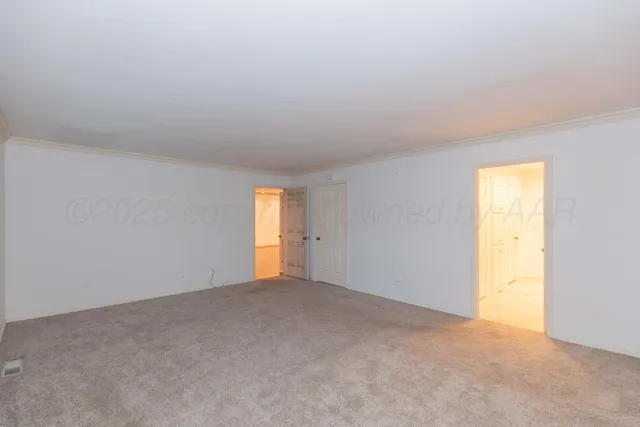 a view of an empty room and a window