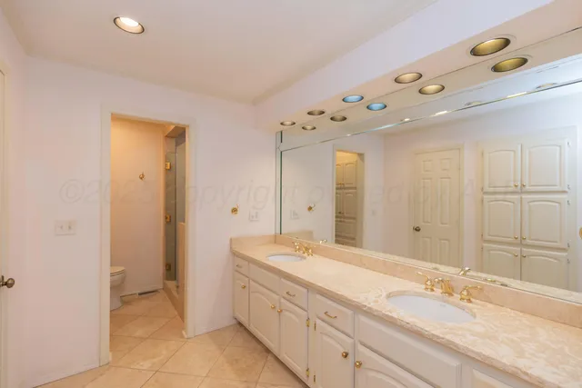 a spacious bathroom with a granite countertop sink mirror and double