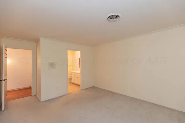 a view of an empty room and a window