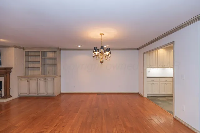 an empty room with closet and windows