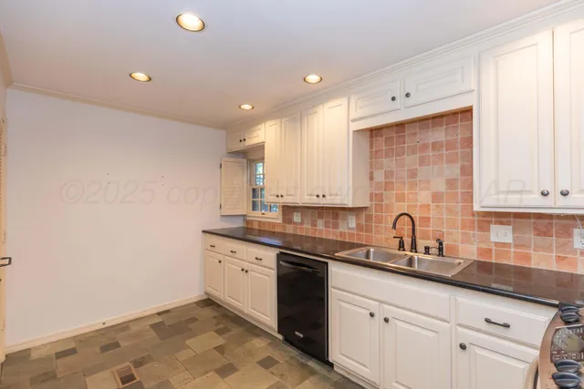 a kitchen with a sink cabinets and window