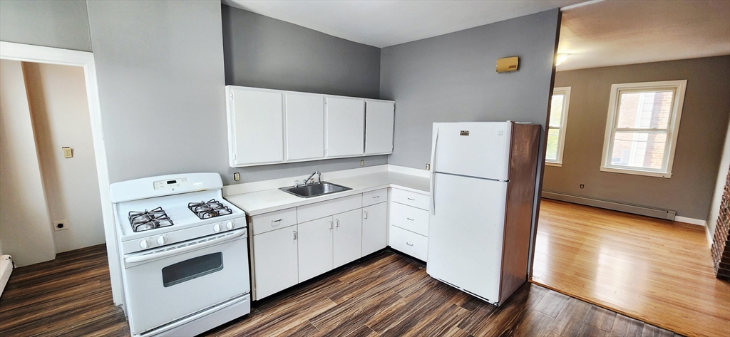 3 Wilbur Court, Unit 2 Boston, MA 02128 - Photo 1 of 25 a kitchen with white cabinets and white appliances