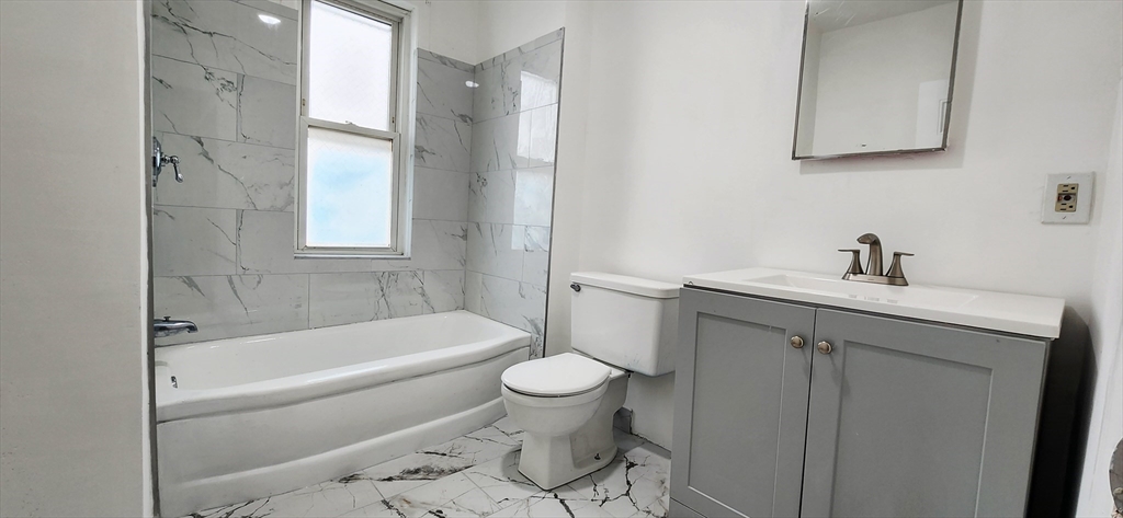 3 Wilbur Court, Unit 2 Boston, MA 02128 - Photo 11 of 25 a bathroom with a sink a toilet and a bathtub