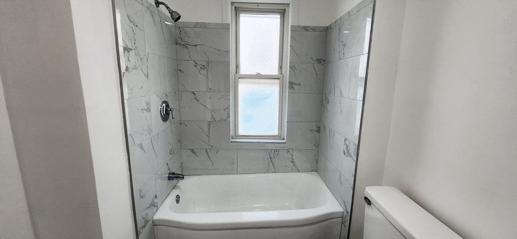 3 Wilbur Court, Unit 2 Boston, MA 02128 - Photo 12 of 25 a bathroom with a tub and a shower