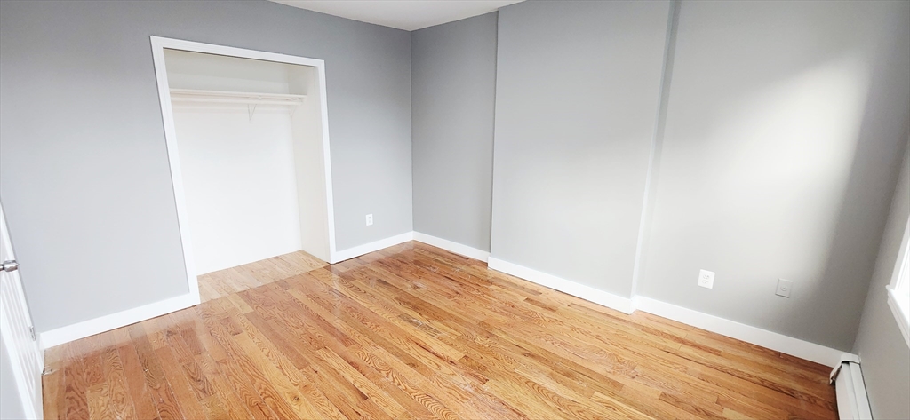 3 Wilbur Court, Unit 2 Boston, MA 02128 - Photo 15 of 25 a view of empty room with wooden floor