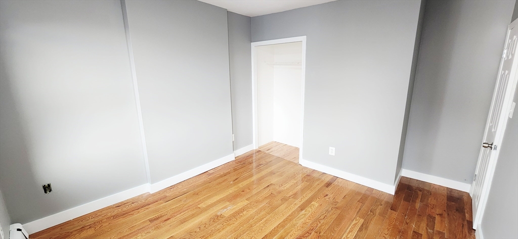 3 Wilbur Court, Unit 2 Boston, MA 02128 - Photo 17 of 25 a view of empty room with wooden floor
