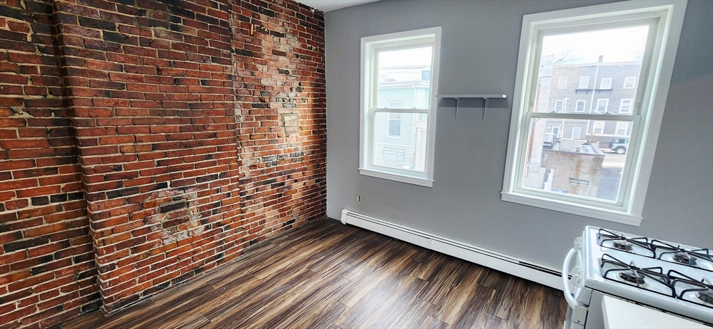 3 Wilbur Court, Unit 2 Boston, MA 02128 - Photo 3 of 25 a view of a room with wooden floor and a window