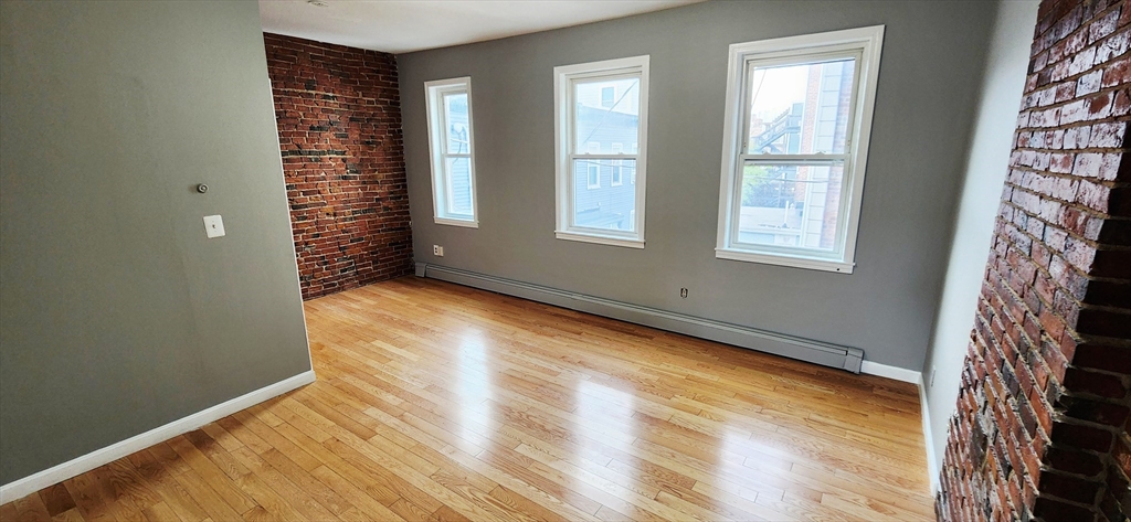3 Wilbur Court, Unit 2 Boston, MA 02128 - Photo 7 of 25 an empty room with windows