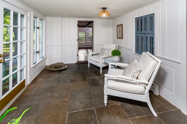 a living room with furniture windows and a potted plant
