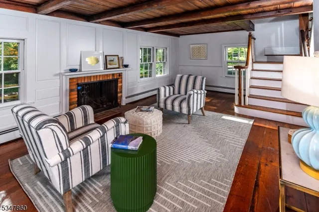 a view of a livingroom with furniture window and wooden floor