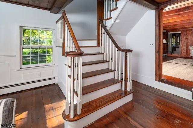 a view of entryway with wooden floor and stairs