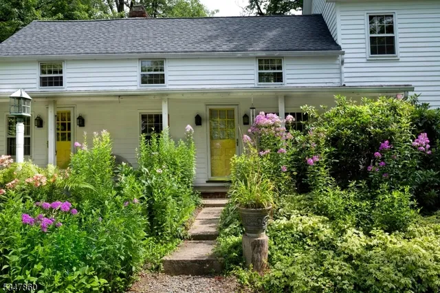 a front view of a house with plants