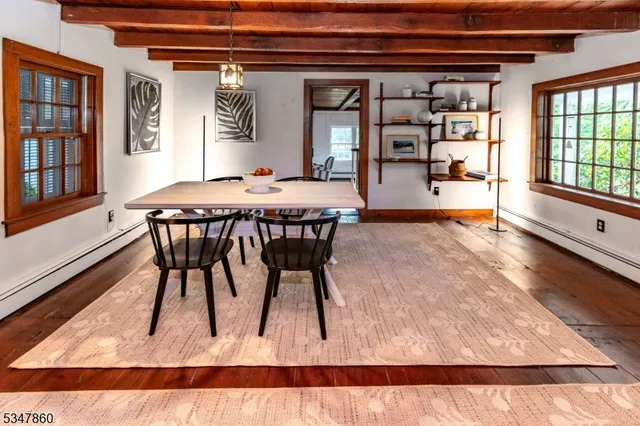 a dining room with a wooden table and chairs