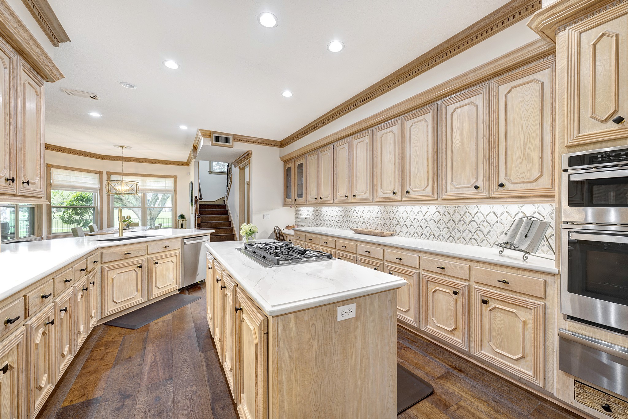 14310 Spring Maple Lane Houston, TX 77062 - Photo 11 of 40 a kitchen with granite countertop a sink stove cabinets and wooden floor