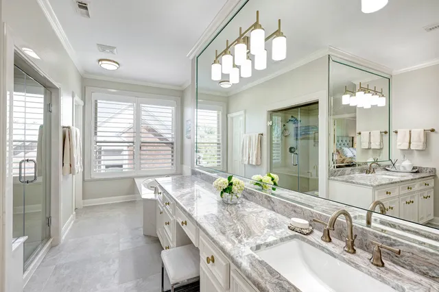 a spacious bathroom with a granite countertop sink a large mirror and a bathtub next to a window