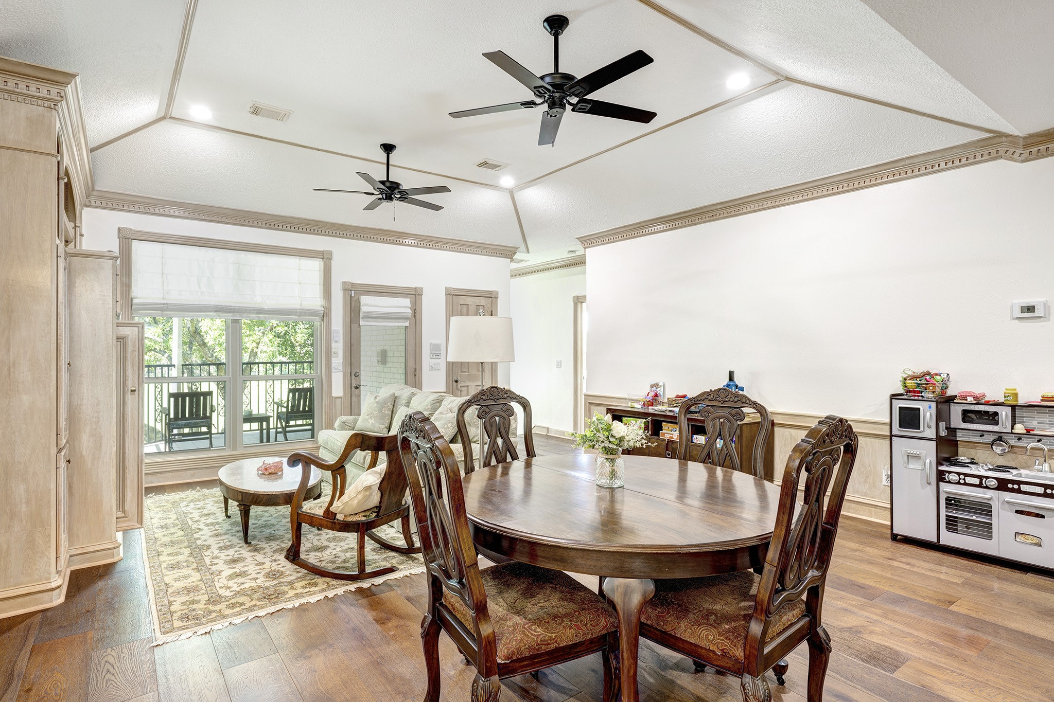 14310 Spring Maple Lane Houston, TX 77062 - Photo 19 of 40 a view of a dining room with furniture window and wooden floor