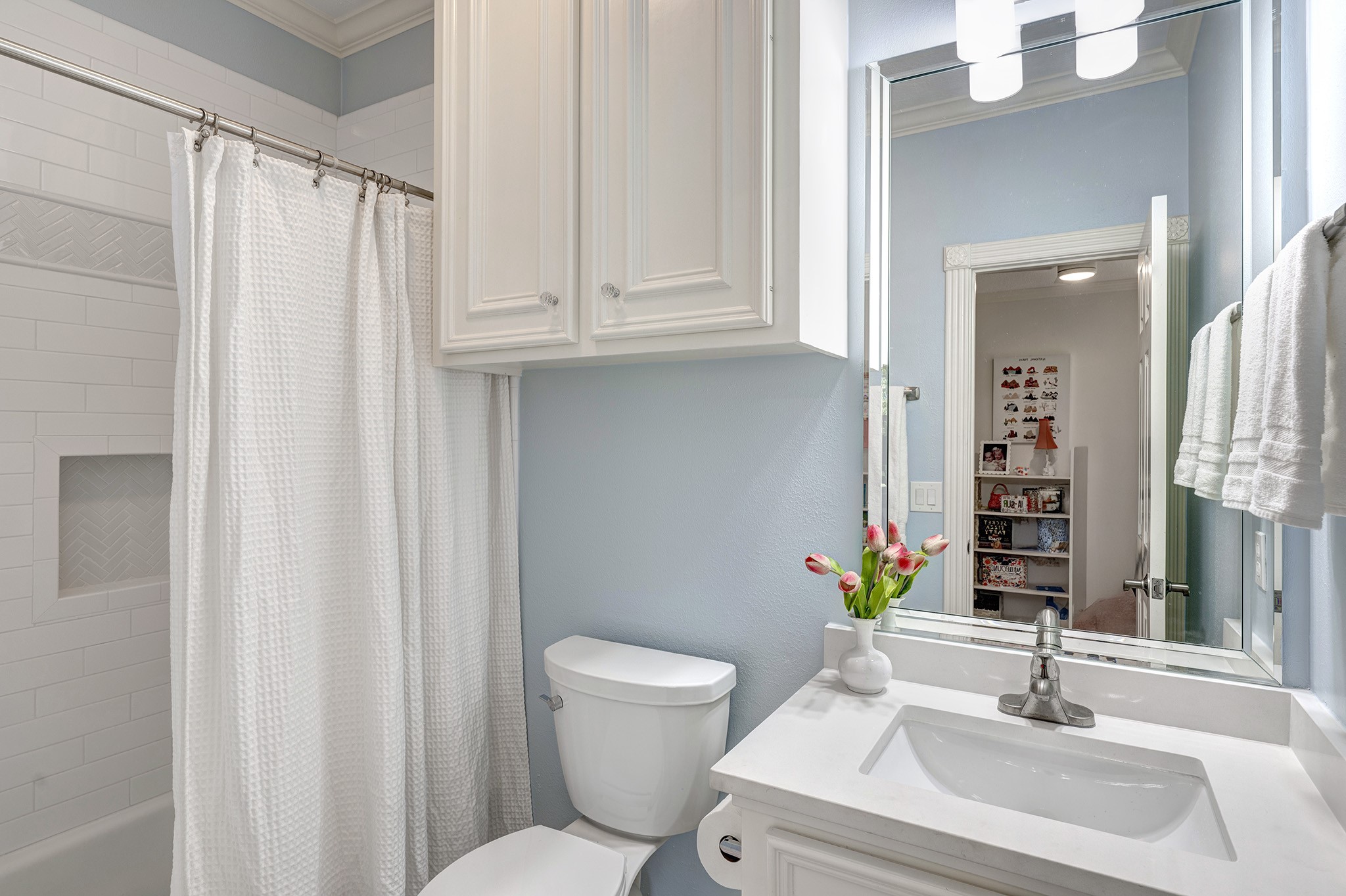 14310 Spring Maple Lane Houston, TX 77062 - Photo 24 of 40 a bathroom with a sink a toilet and a mirror