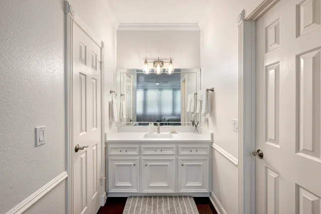 a bathroom with a sink vanity granite and a mirror
