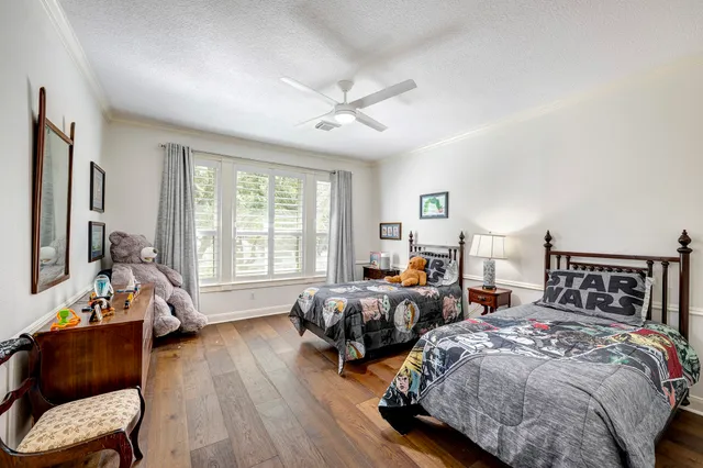 a bedroom with two beds and a large window