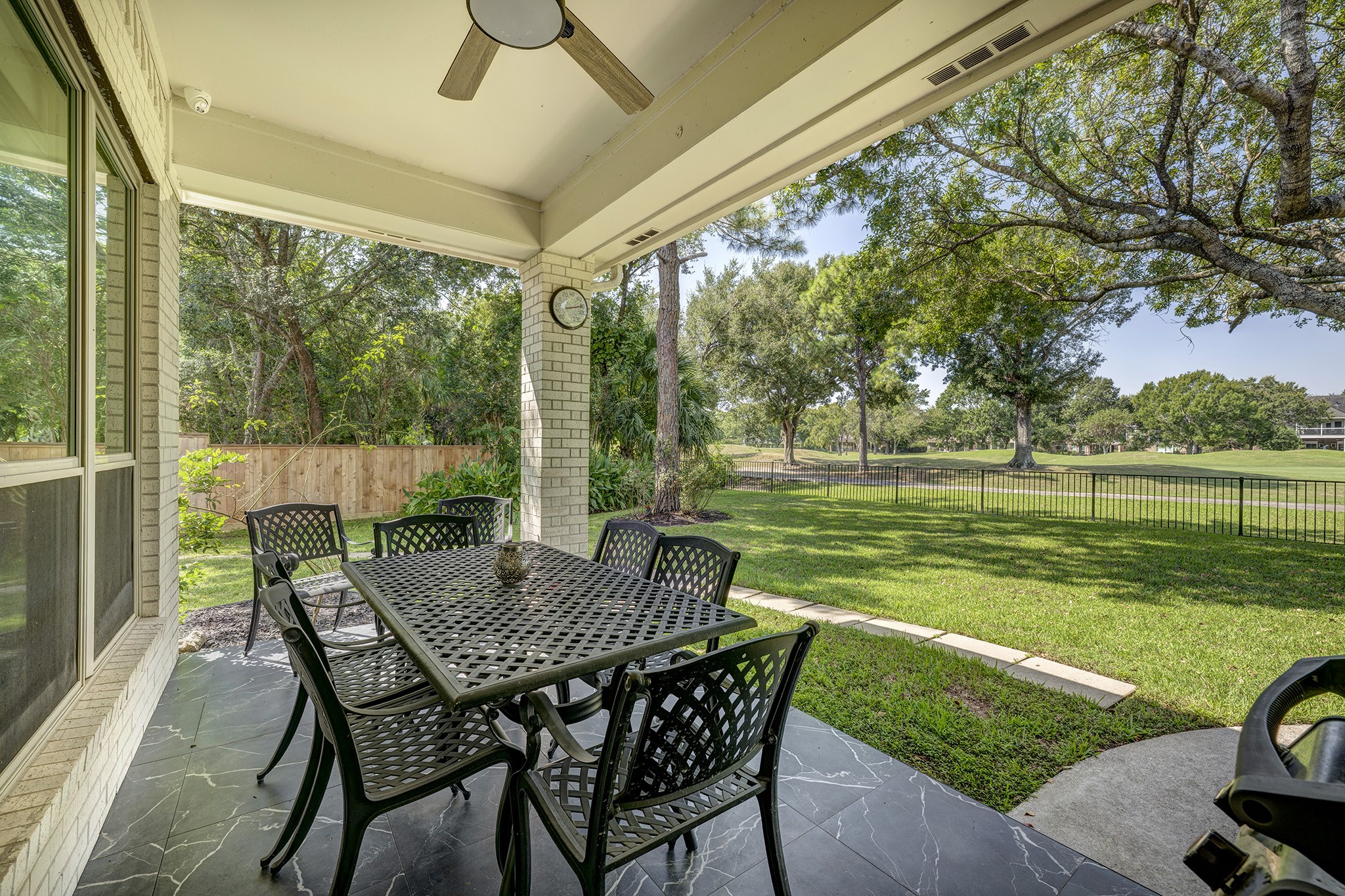 14310 Spring Maple Lane Houston, TX 77062 - Photo 31 of 40 a view of a patio with a table chairs and a backyard