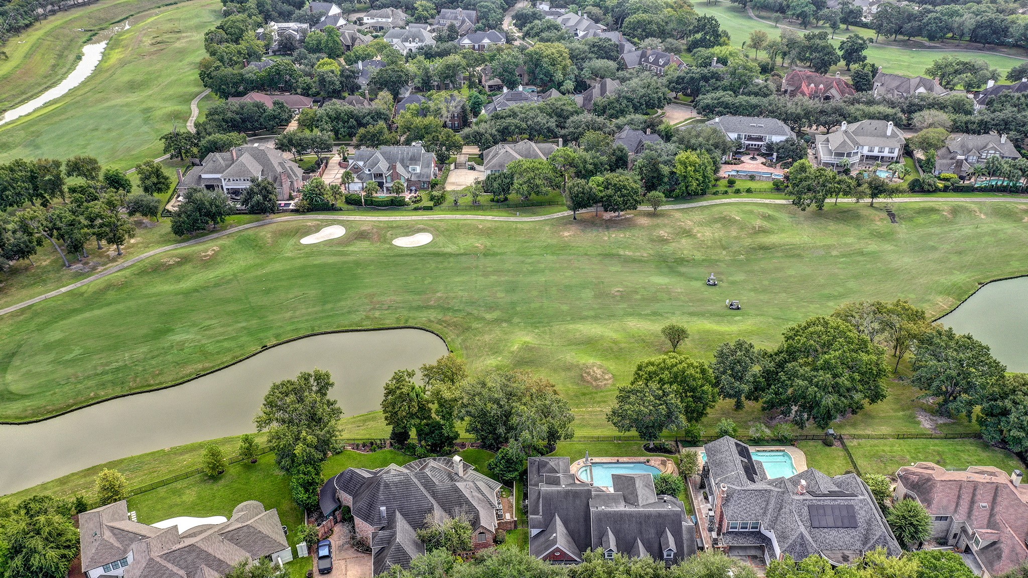 14310 Spring Maple Lane Houston, TX 77062 - Photo 40 of 40 an aerial view of a house with outdoor space swimming pool lake and outdoor seating