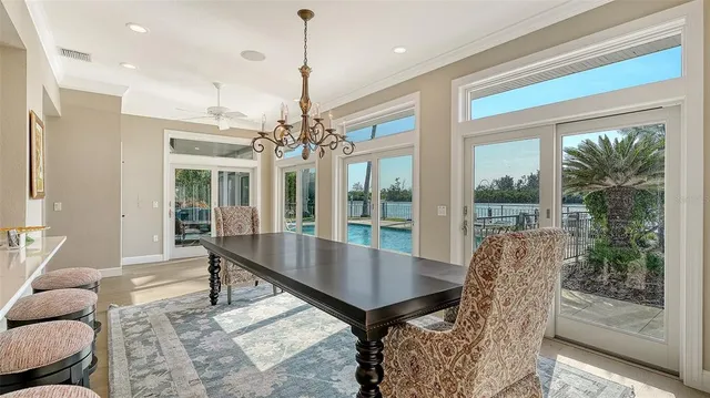 a view of a lake with a barbeque and wooden bridge