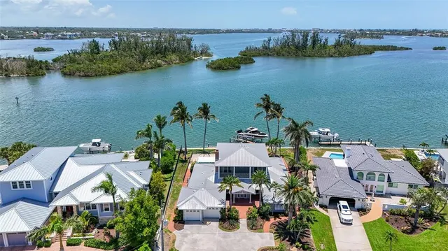 a living room with furniture and large windows