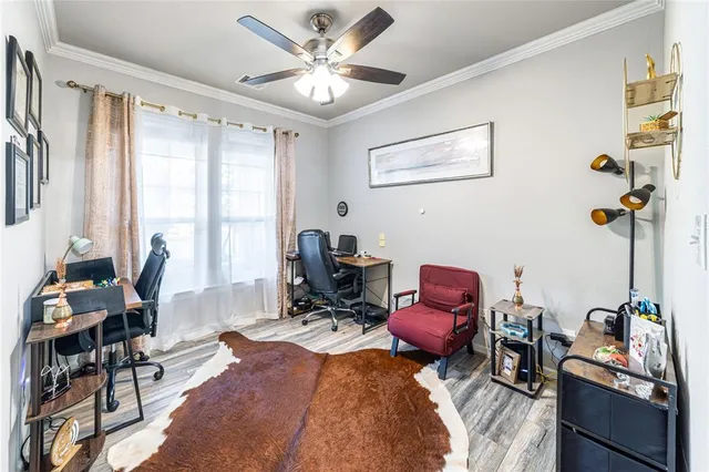 a view of a workspace with furniture and a window