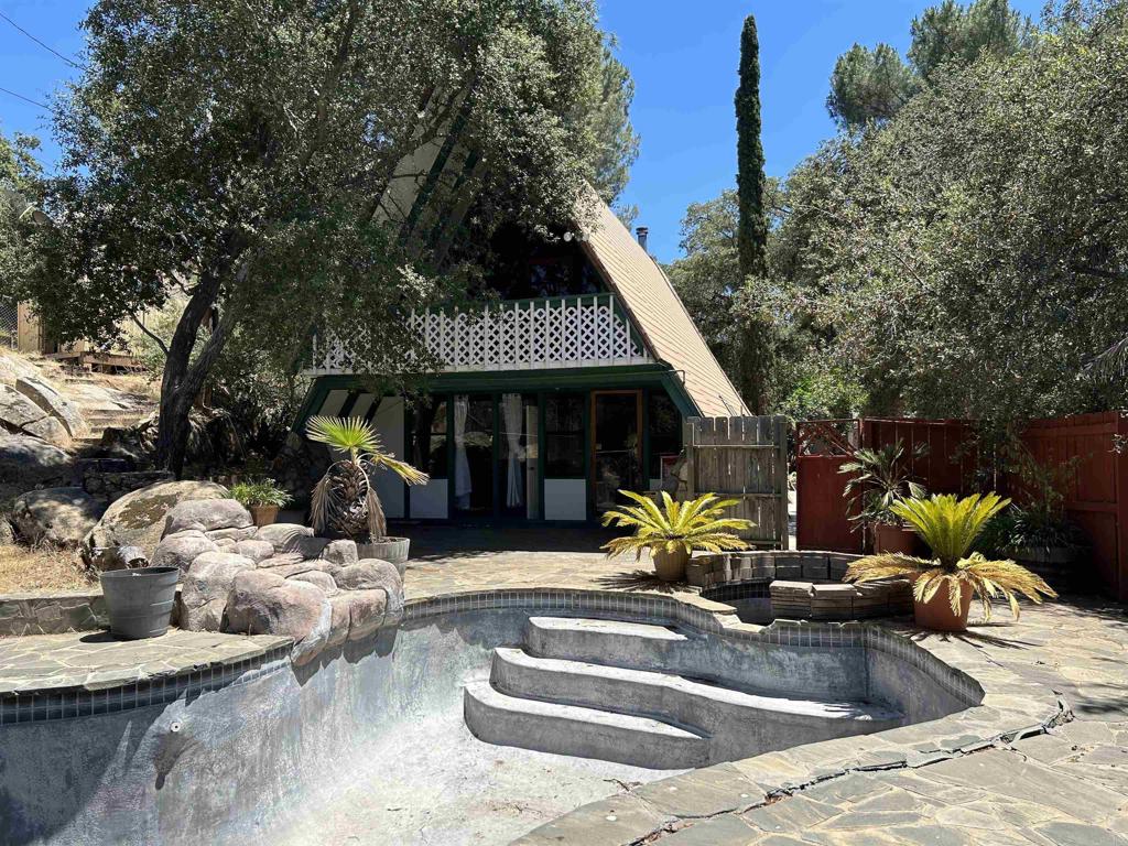 a view of a house with swimming pool and sitting area