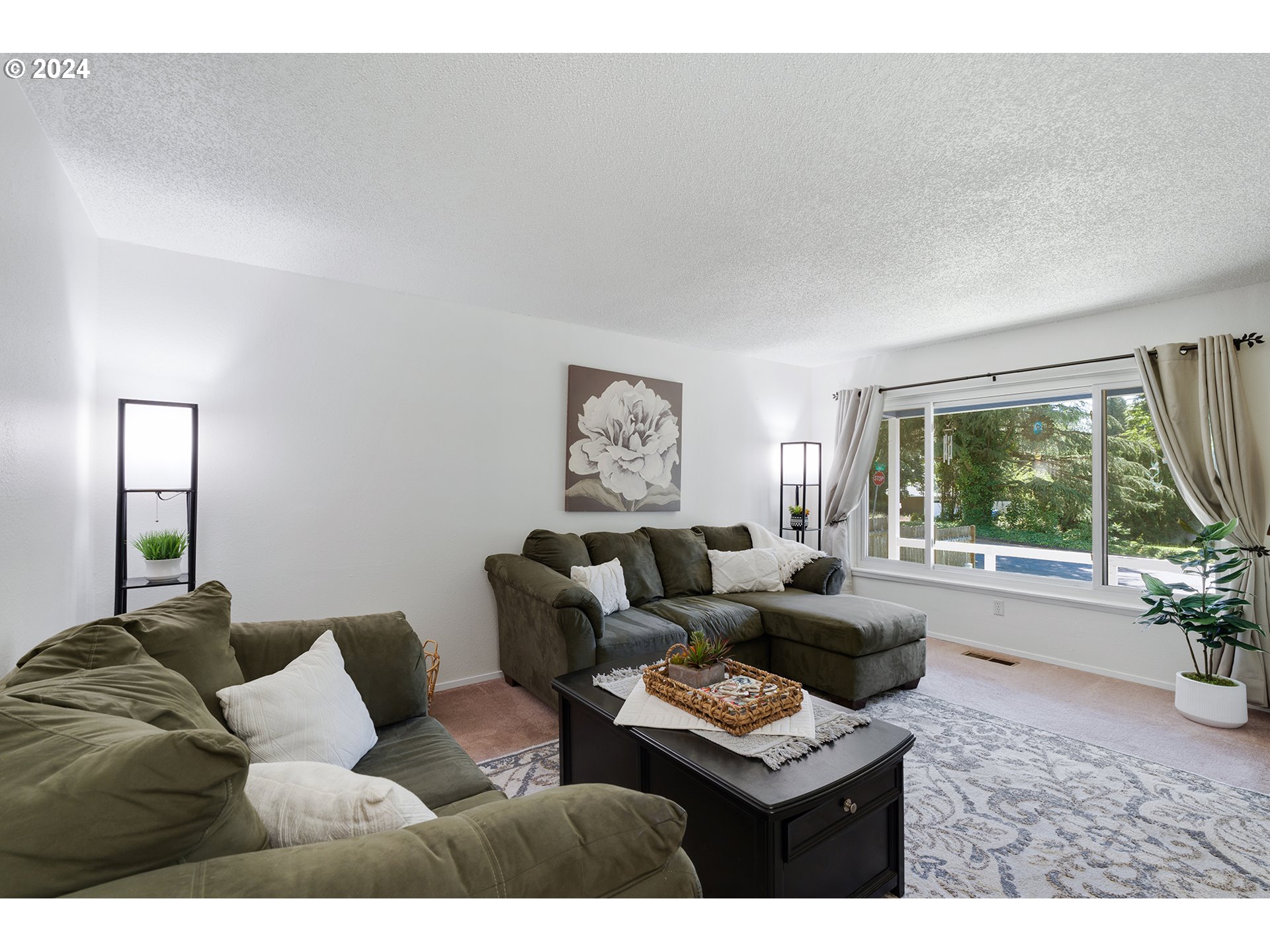 7946 Southeast 103rd Avenue Portland, OR 97266 - Photo 11 of 32 a living room with furniture and a large window